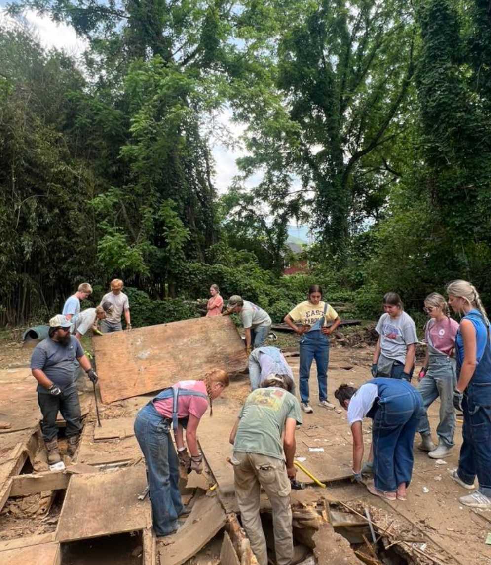 Youth group from the NC Conference of the Global Methodist Church working on a mission project outdoors 🏷️ Title: